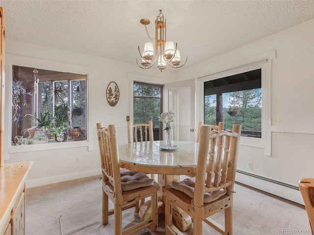dining room with a chandelier, light carpet, a textured ceiling, and a baseboard heating unit