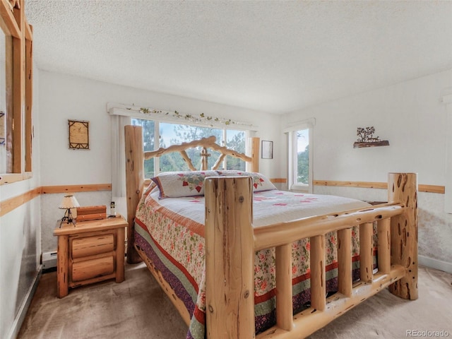 bedroom featuring baseboard heating and carpet