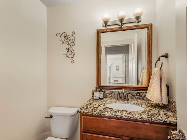 bathroom with toilet and vanity