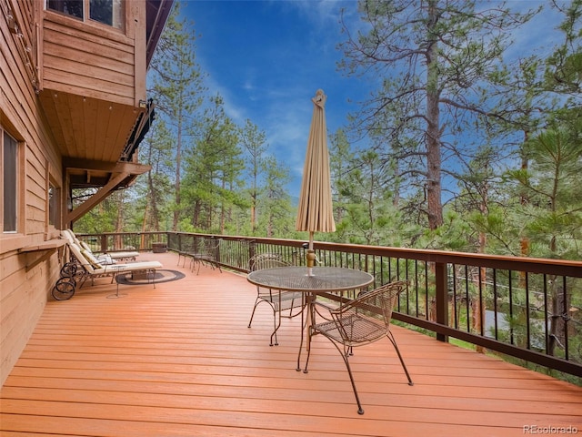 wooden deck with outdoor dining space