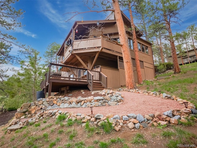rear view of property with a wooden deck