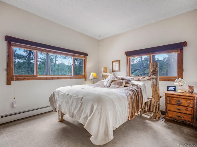 carpeted bedroom featuring a baseboard radiator