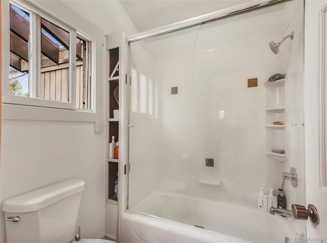 full bathroom featuring toilet and shower / bath combination with glass door