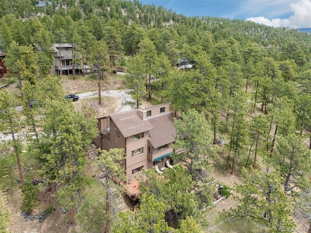 bird's eye view with a wooded view