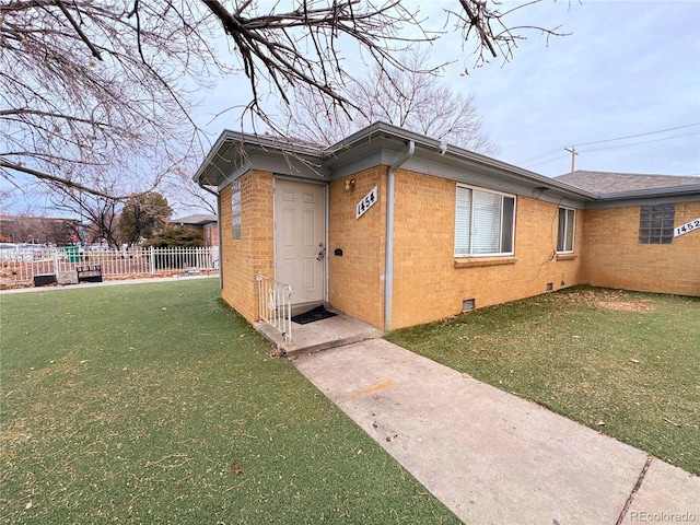 view of side of home with a yard