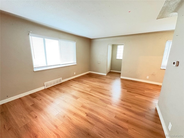 spare room featuring light wood-type flooring