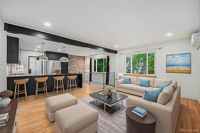 1111 Monroe St, Denver, CO 80206 - living area with light wood finished floors, baseboards, and recessed lighting