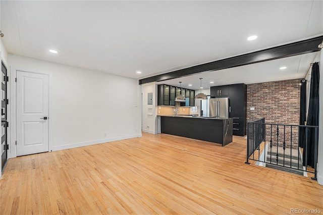 1111 Monroe St, Denver, CO 80206 - unfurnished living room featuring light wood-style flooring, baseboards, and recessed lighting