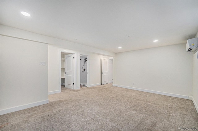 1111 Monroe St, Denver, CO 80206 - finished below grade area with light colored carpet, a wall unit AC, recessed lighting, and baseboards