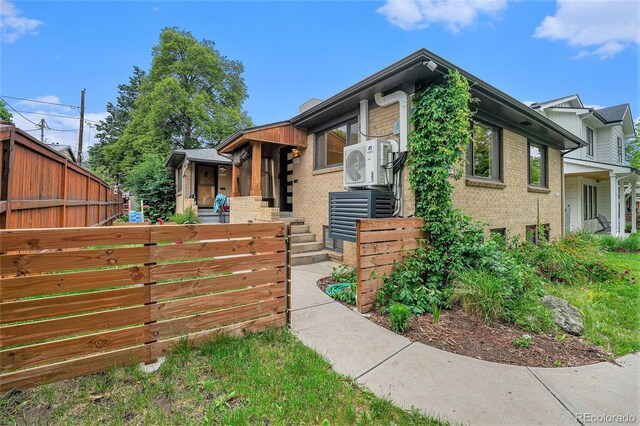 1111 Monroe St, Denver, CO 80206 - tri-level home with brick siding and a cooling unit