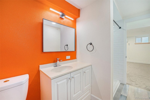 1111 Monroe St, Denver, CO 80206 - bathroom with vanity, a shower, toilet, and wood finished floors