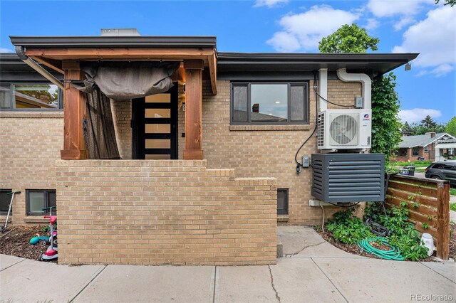 1111 Monroe St, Denver, CO 80206 - view of front of house featuring brick siding and ac unit