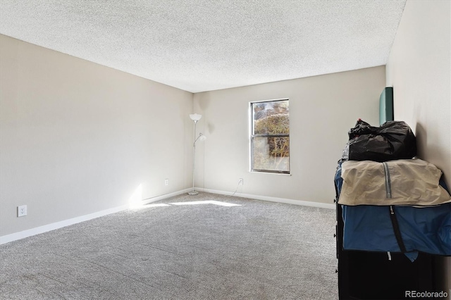 bedroom featuring carpet flooring and a textured ceiling