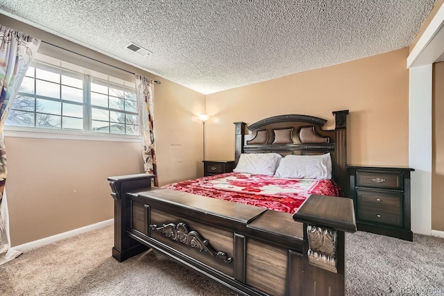 bedroom with carpet flooring and a textured ceiling