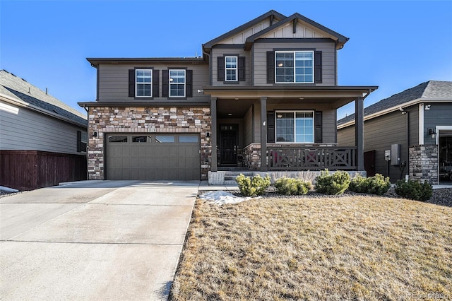 craftsman-style home with driveway, stone siding, an attached garage, a porch, and board and batten siding