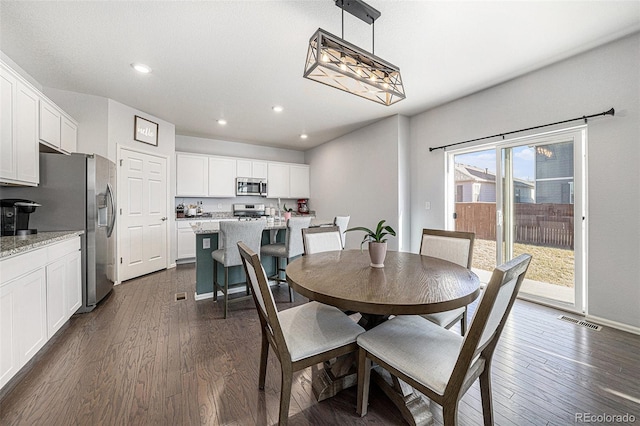 dining room with baseboards, dark wood-type flooring, visible vents, and recessed lighting