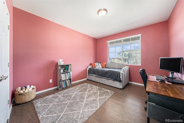 bedroom featuring wood finished floors and baseboards