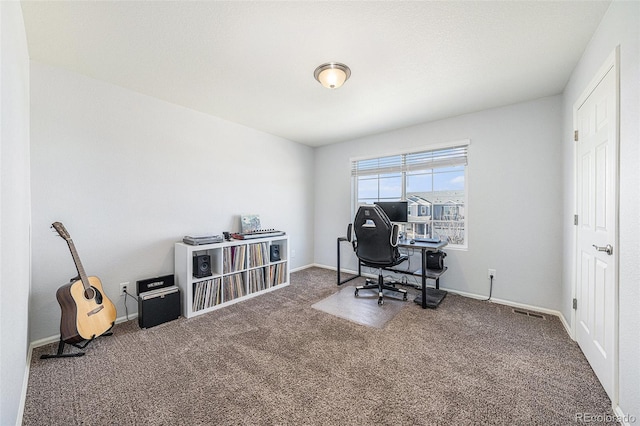 carpeted office space with visible vents and baseboards