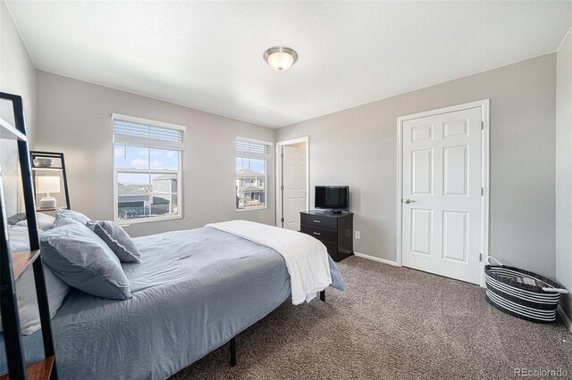 carpeted bedroom with baseboards