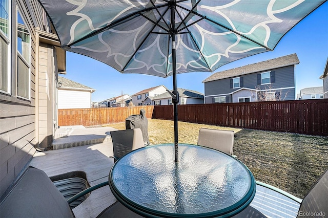 view of patio / terrace featuring outdoor dining area, a fenced backyard, and a residential view