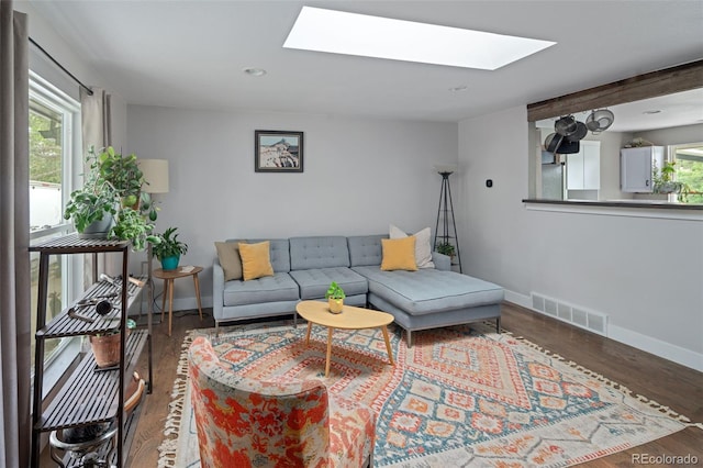8764 W 95th Ave, Broomfield, CO 80021 - living room featuring a skylight, baseboards, wood finished floors, and recessed lighting