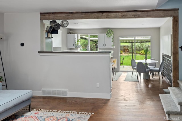 8764 W 95th Ave, Broomfield, CO 80021 - living area with wood finished floors, a fireplace, baseboards, and beam ceiling