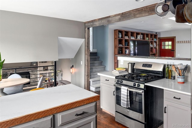 8764 W 95th Ave, Broomfield, CO 80021 - kitchen featuring gas range, light countertops, dark wood-style flooring, and fridge