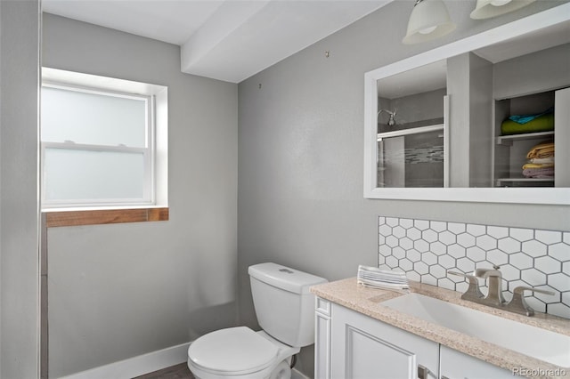 8764 W 95th Ave, Broomfield, CO 80021 - full bathroom with backsplash, vanity, toilet, and a tile shower