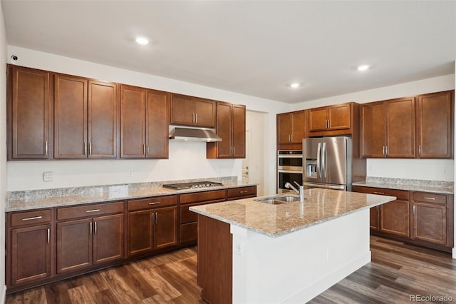 kitchen with a sink, stainless steel appliances, dark wood-style flooring, and under cabinet range hood