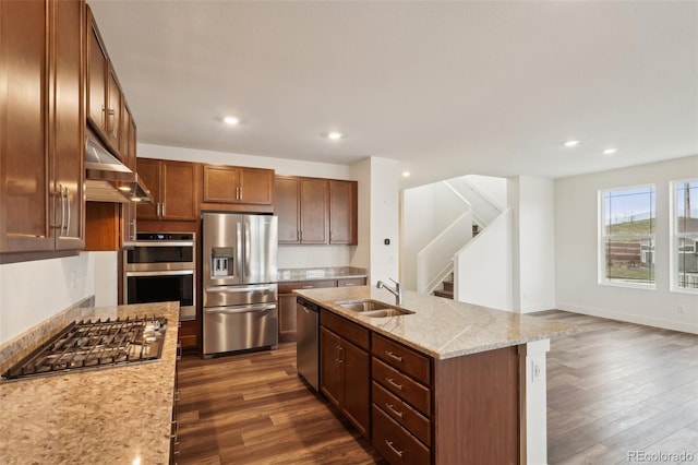 kitchen with a sink, range hood, stainless steel appliances, and dark wood-type flooring
