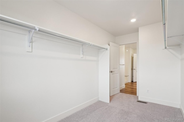 walk in closet featuring carpet floors and visible vents