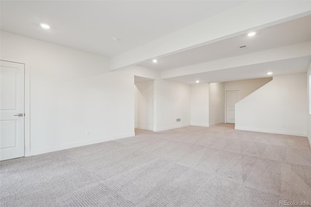 interior space featuring baseboards, light carpet, and recessed lighting