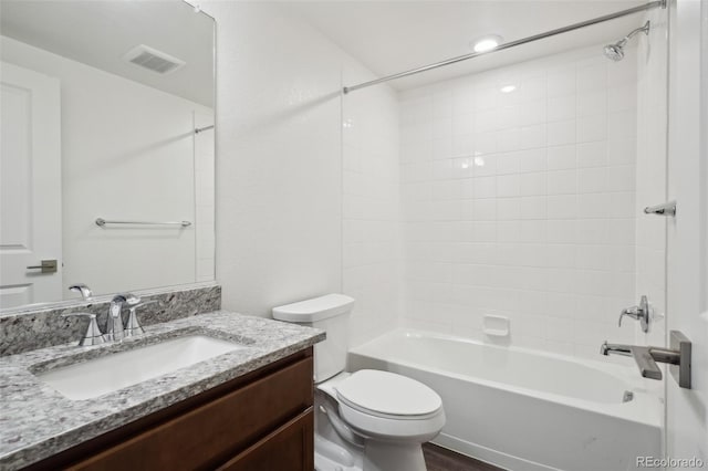 full bathroom with visible vents, shower / bathing tub combination, toilet, and vanity