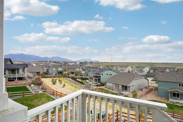 balcony featuring a residential view and a mountain view