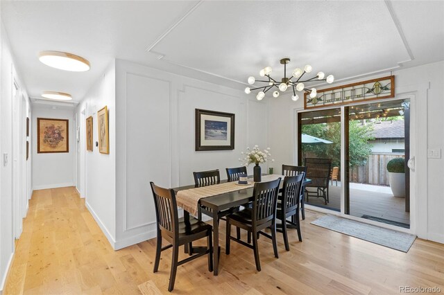 dining room with a notable chandelier and light hardwood / wood-style flooring