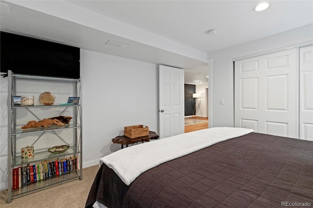 carpeted bedroom with a closet