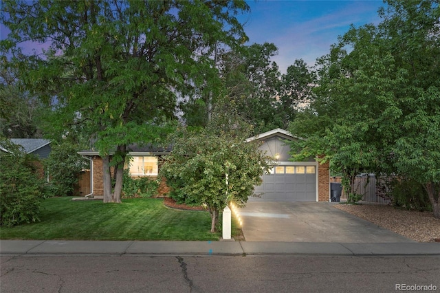 view of front of property with a garage and a yard