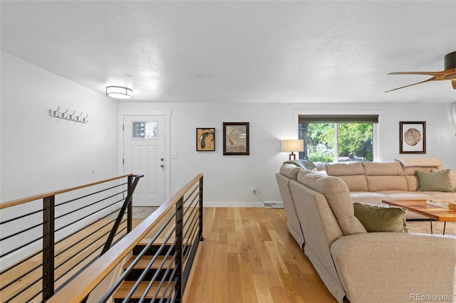 living room with a textured ceiling and light hardwood / wood-style flooring