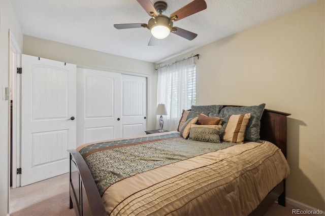 carpeted bedroom with a closet and a ceiling fan