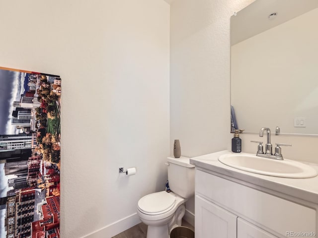 bathroom featuring toilet and vanity