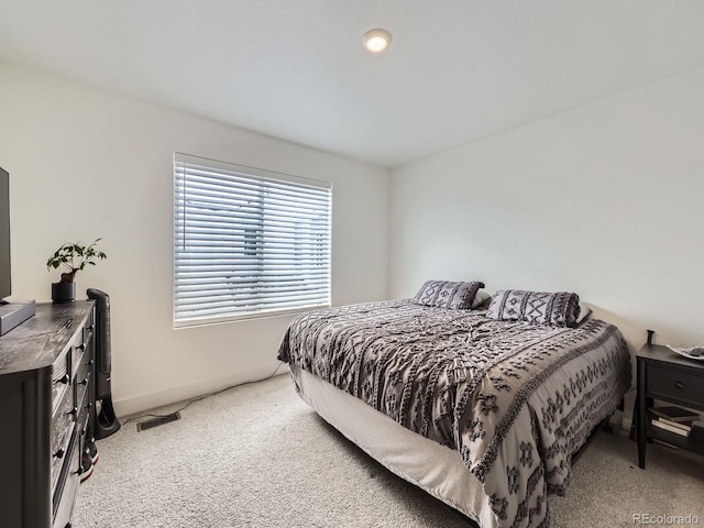 bedroom with light colored carpet