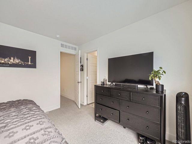 bedroom with light colored carpet