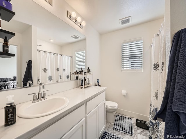 bathroom with toilet and vanity