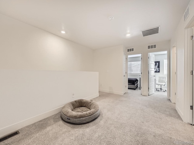 unfurnished room featuring light colored carpet