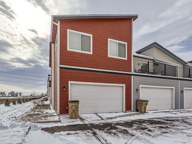 view of front of home with a garage and a balcony