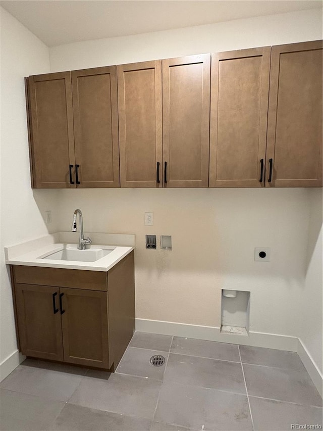 washroom featuring cabinets, hookup for a washing machine, electric dryer hookup, sink, and light tile patterned flooring