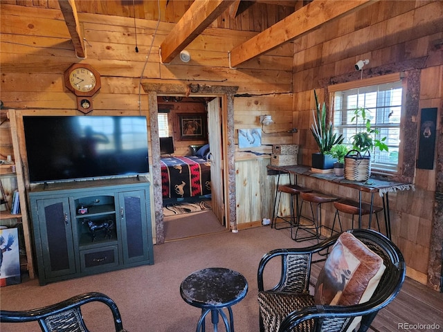 interior space featuring carpet flooring, beam ceiling, wood ceiling, and wooden walls