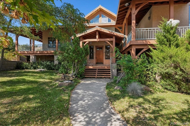 view of front of property with a front yard and stucco siding