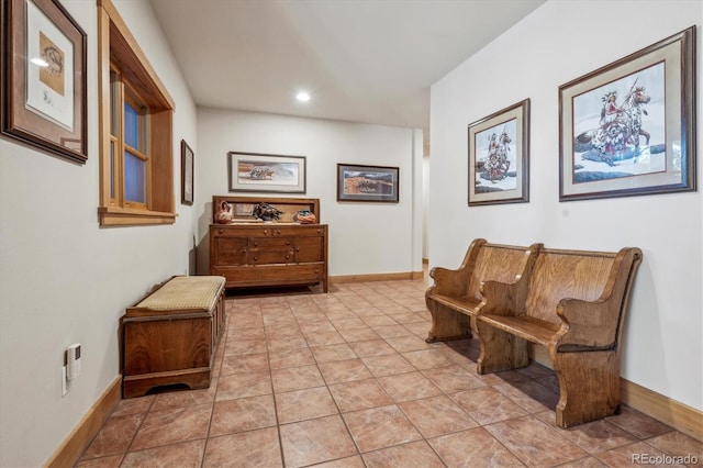 living area featuring baseboards and recessed lighting