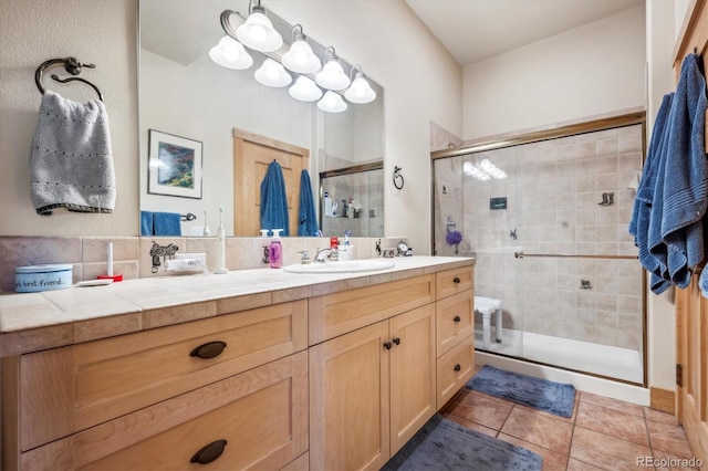 full bathroom featuring vanity, a shower stall, and tile patterned flooring